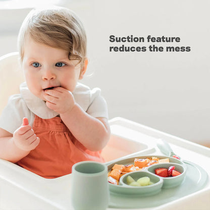 Child in a high chair with a tray of food and text 'Suction feature reduces the mess'.